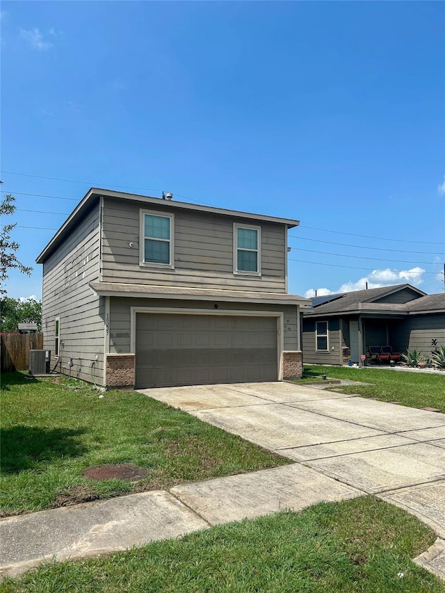 view of front of house featuring concrete driveway, brick siding, a front yard, and a garage