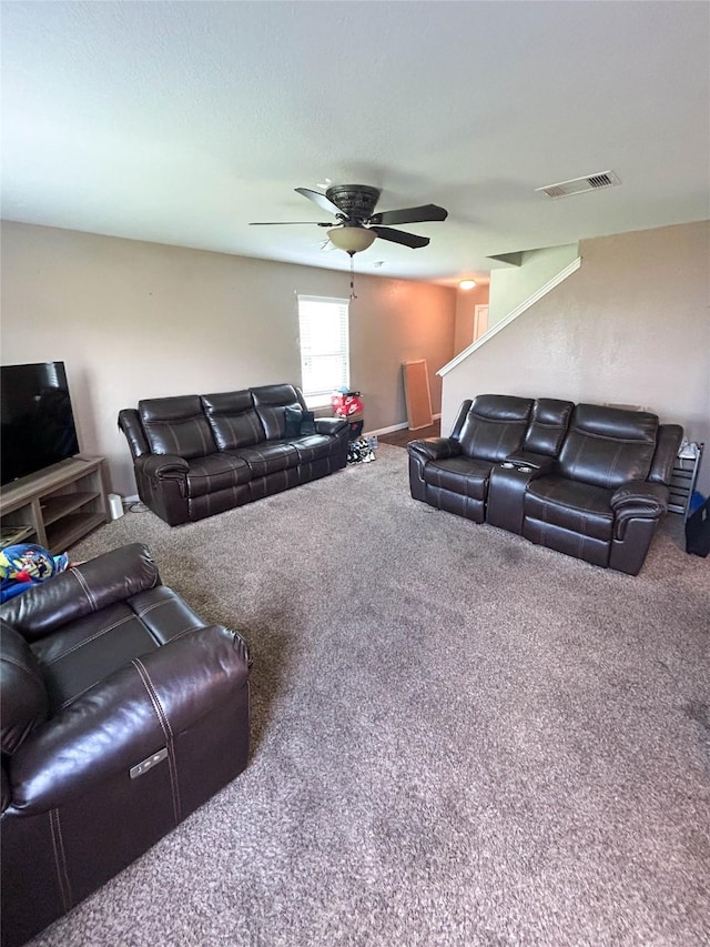 carpeted living area with visible vents and ceiling fan
