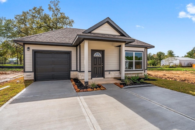11885 E Gate Dr, Willis, TX 77318 - view of front of property with an attached garage, a shingled roof, and driveway