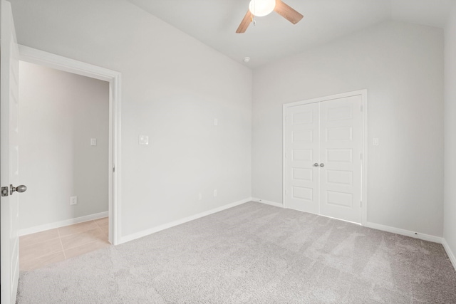11885 E Gate Dr, Willis, TX 77318 - carpeted empty room featuring baseboards, a ceiling fan, lofted ceiling, and tile patterned flooring