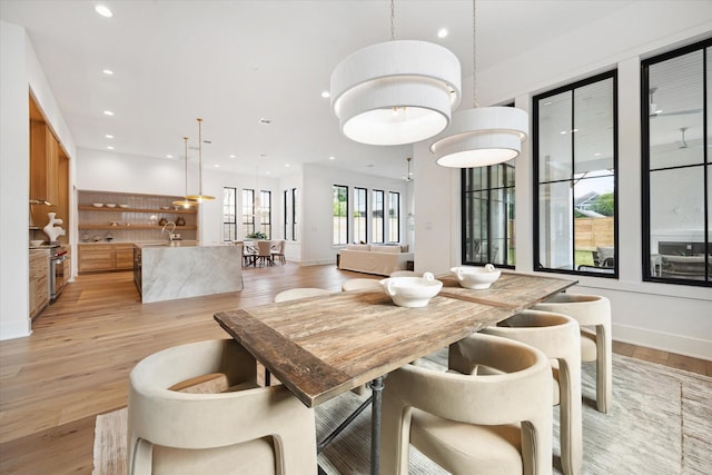 dining room featuring recessed lighting, light wood-style flooring, and baseboards