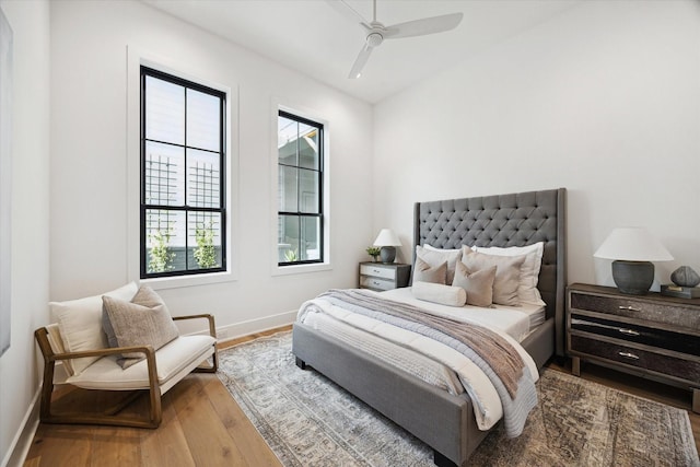 bedroom featuring baseboards, ceiling fan, and wood finished floors