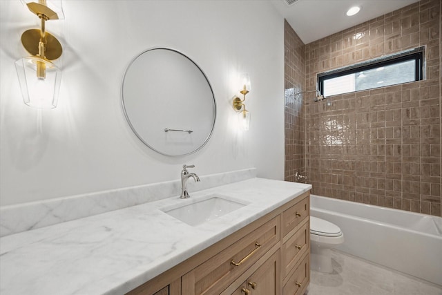 bathroom with vanity, toilet, and  shower combination