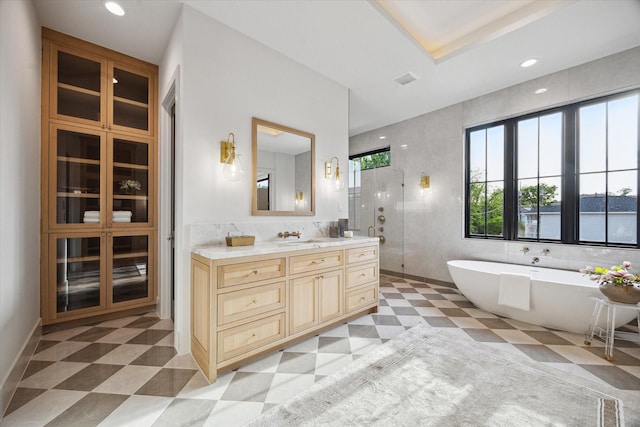 702 E 19th St, Houston, TX 77008 - bathroom featuring a stall shower, a soaking tub, vanity, tile patterned floors, and tile walls