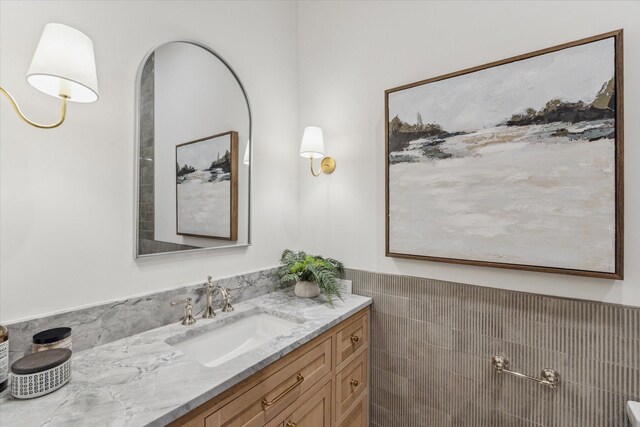 702 E 19th St, Houston, TX 77008 - bathroom featuring vanity, tile walls, and wainscoting
