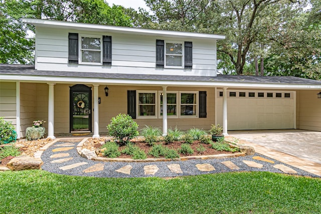 traditional-style house with a porch, a garage, roof with shingles, and driveway