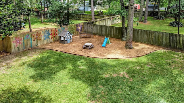 view of jungle gym featuring a lawn and fence