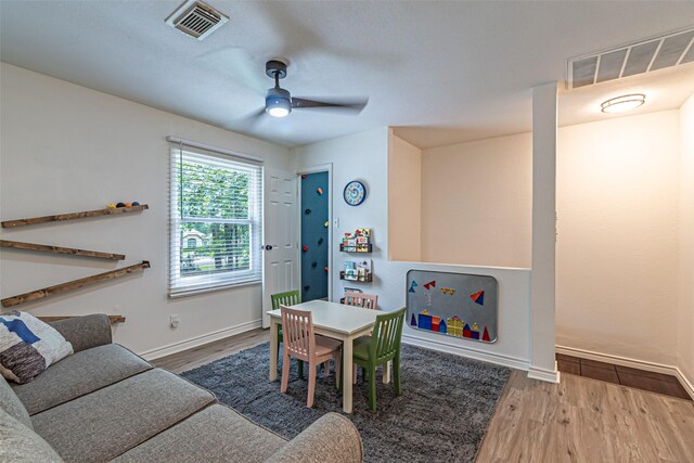playroom featuring a ceiling fan, baseboards, visible vents, and wood finished floors