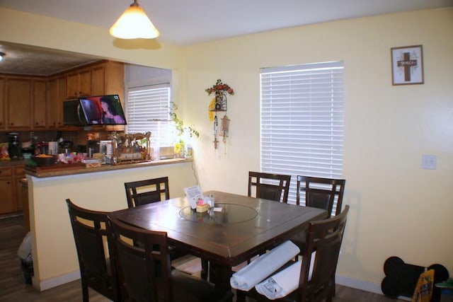 7721 Brumblay St, Houston, TX 77012 - dining space featuring dark wood-style floors