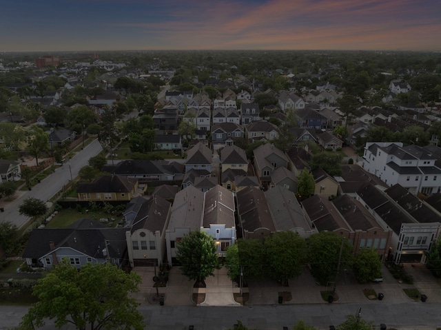 aerial view at dusk featuring a residential view