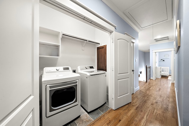 1538 Dorothy St, Houston, TX 77008 - laundry area featuring attic access, washing machine and clothes dryer, radiator heating unit, and light wood-style flooring