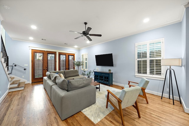 living room featuring crown molding, stairs, baseboards, ceiling fan, and french doors