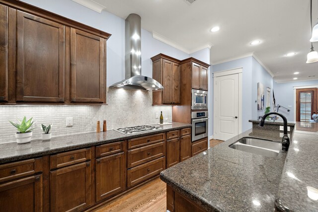 1538 Dorothy St, Houston, TX 77008 - kitchen featuring wall chimney range hood, appliances with stainless steel finishes, a sink, crown molding, and decorative backsplash