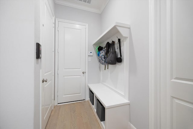 mudroom with crown molding and light wood finished floors