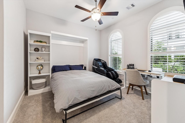 bedroom featuring a ceiling fan, baseboards, visible vents, and light carpet
