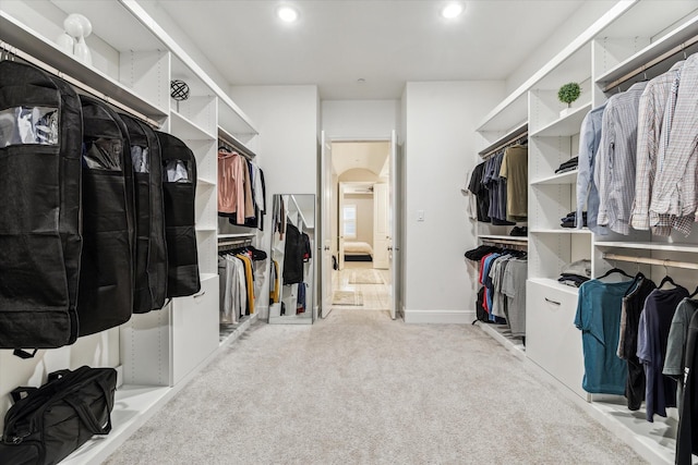 846 Dunleigh Meadows Ln, Houston, TX 77055 - walk in closet featuring light colored carpet and arched walkways