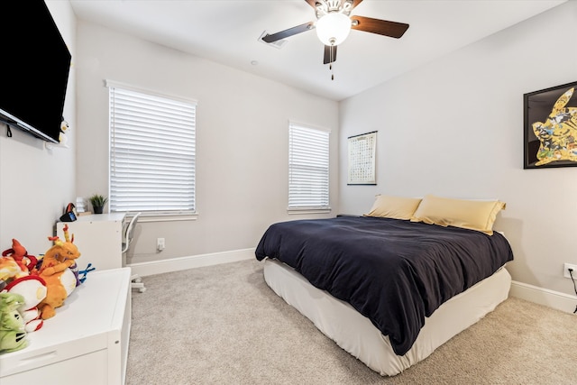 carpeted bedroom with a ceiling fan and baseboards