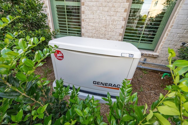 details featuring brick siding and a power unit