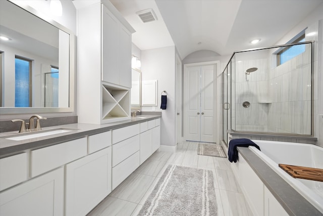 full bath with a washtub, visible vents, a sink, and a stall shower