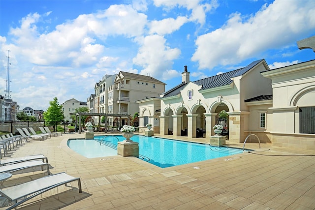 pool featuring a residential view and a patio