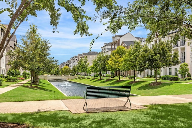 view of property's community with a lawn and a residential view