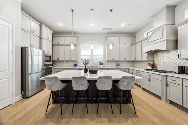 846 Dunleigh Meadows Ln, Houston, TX 77055 - kitchen featuring appliances with stainless steel finishes, recessed lighting, a center island, decorative backsplash, and a kitchen breakfast bar