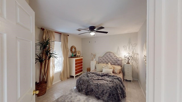bedroom featuring a ceiling fan, baseboards, visible vents, and light tile patterned floors