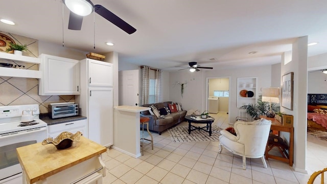 living room with ceiling fan, washer / clothes dryer, a toaster, recessed lighting, and light tile patterned flooring