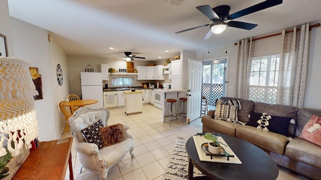 living room with recessed lighting, ceiling fan, and light tile patterned floors