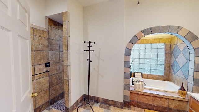 full bath featuring walk in shower and a bath