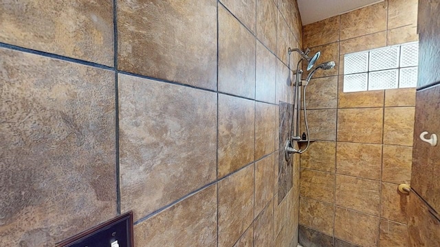 interior details featuring a tile shower
