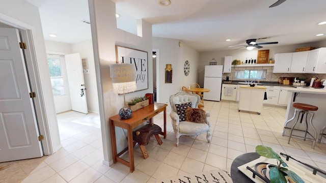 living room featuring light tile patterned floors, ceiling fan, and recessed lighting
