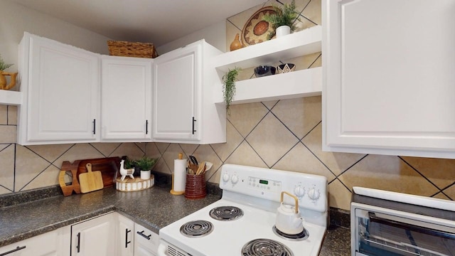 kitchen with white electric range, open shelves, white cabinetry, and tasteful backsplash