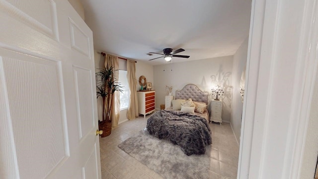 bedroom featuring light tile patterned flooring and a ceiling fan