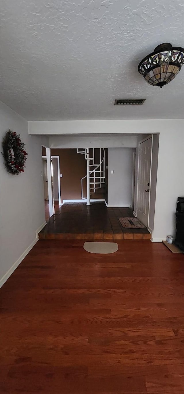 532 S Rivershire Dr, Conroe, TX 77304 - corridor with wood finished floors, a textured ceiling, and baseboards