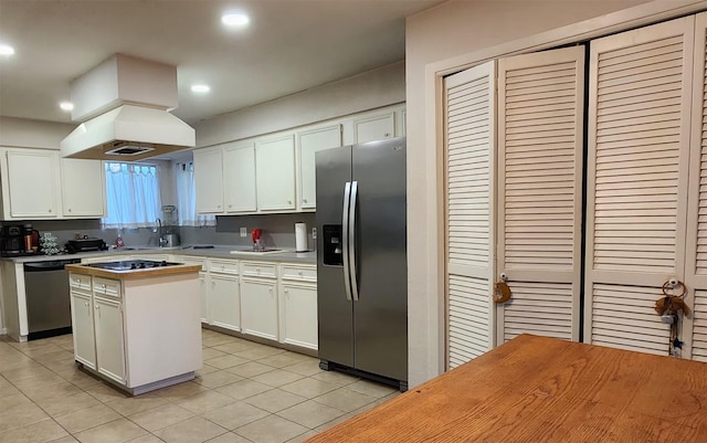 532 S Rivershire Dr, Conroe, TX 77304 - kitchen with appliances with stainless steel finishes, light tile patterned floors, a center island, white cabinetry, and recessed lighting