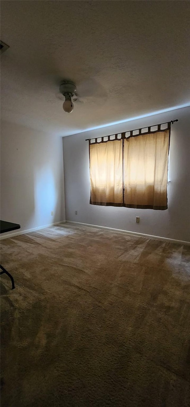 532 S Rivershire Dr, Conroe, TX 77304 - spare room with dark colored carpet and baseboards