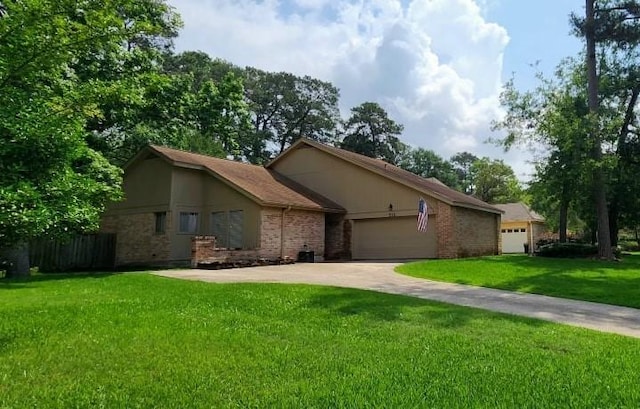 532 S Rivershire Dr, Conroe, TX 77304 - view of front of property featuring a front lawn, a garage, driveway, and brick siding