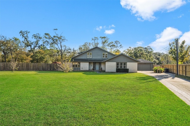 back of property with a lawn, fence, concrete driveway, and a garage