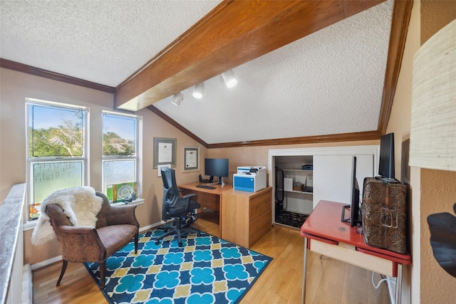 office space with vaulted ceiling with beams, ornamental molding, a textured ceiling, and wood finished floors