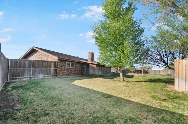 view of yard with a fenced backyard