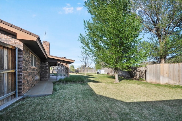 view of yard with a fenced backyard