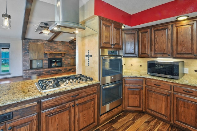 kitchen with dark wood-style flooring, light stone countertops, tasteful backsplash, a ceiling fan, and stainless steel appliances