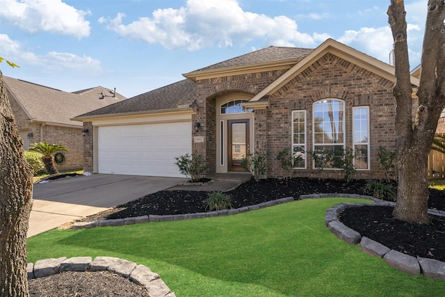 view of front of home featuring a garage, driveway, a front lawn, and brick siding