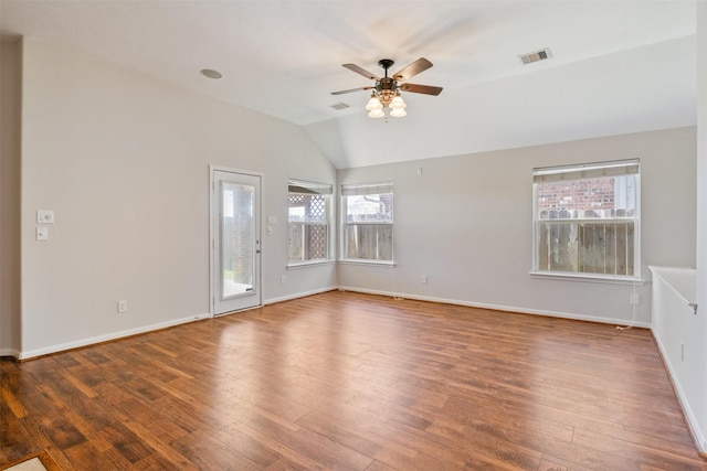 spare room featuring visible vents, lofted ceiling, hardwood / wood-style floors, baseboards, and ceiling fan