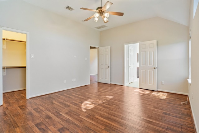 unfurnished bedroom featuring a spacious closet, wood finished floors, and visible vents