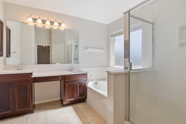 bathroom featuring double vanity, a bath, a shower stall, a sink, and tile patterned floors
