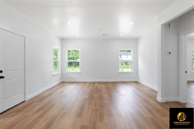 interior space featuring light wood-type flooring, recessed lighting, baseboards, and visible vents