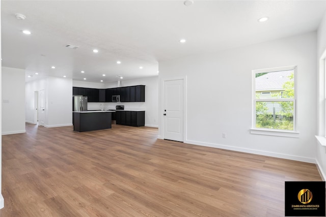 unfurnished living room featuring baseboards, recessed lighting, light wood-style flooring, and visible vents