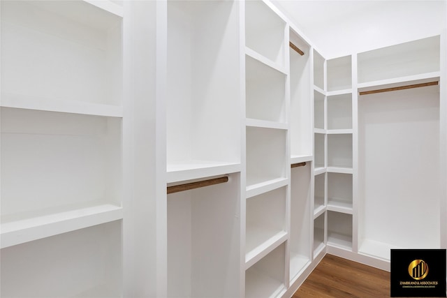 walk in closet with wood finished floors